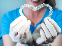 dental professional holding two clear aligners