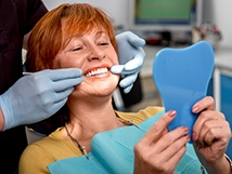 woman smiling after getting implants 