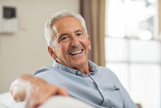 man smiling after getting dentures 